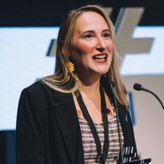 Dr. Sara Correyero speaking on stage